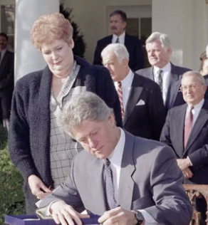 Clinton signs family and medical leave act