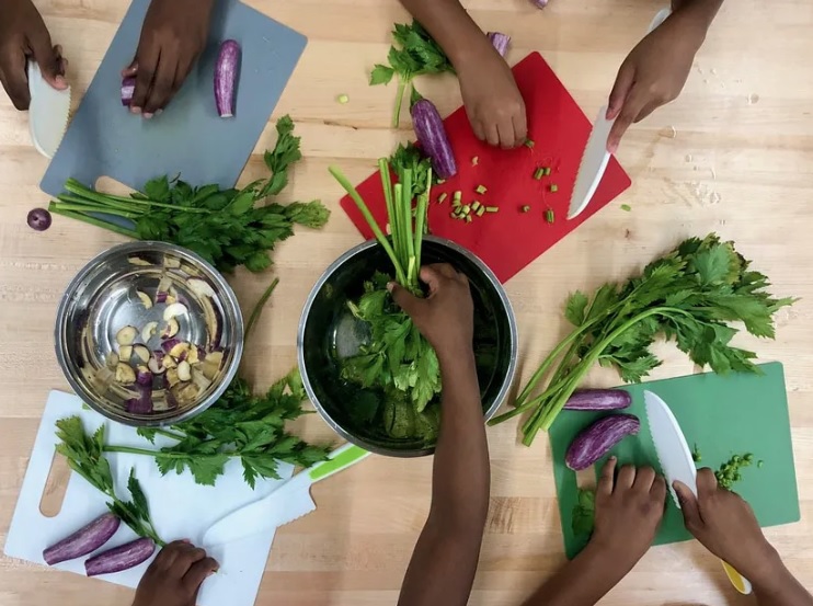Students learn by cooking with the food they grow in their school garden. Photo courtesy of FoodPrints.