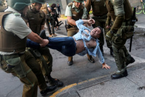 Chile protests: Riot policemen detain a demonstrator during an anti-government protest in Santiago, Chile October 28, 2019. REUTERS/Pablo Sanhueza